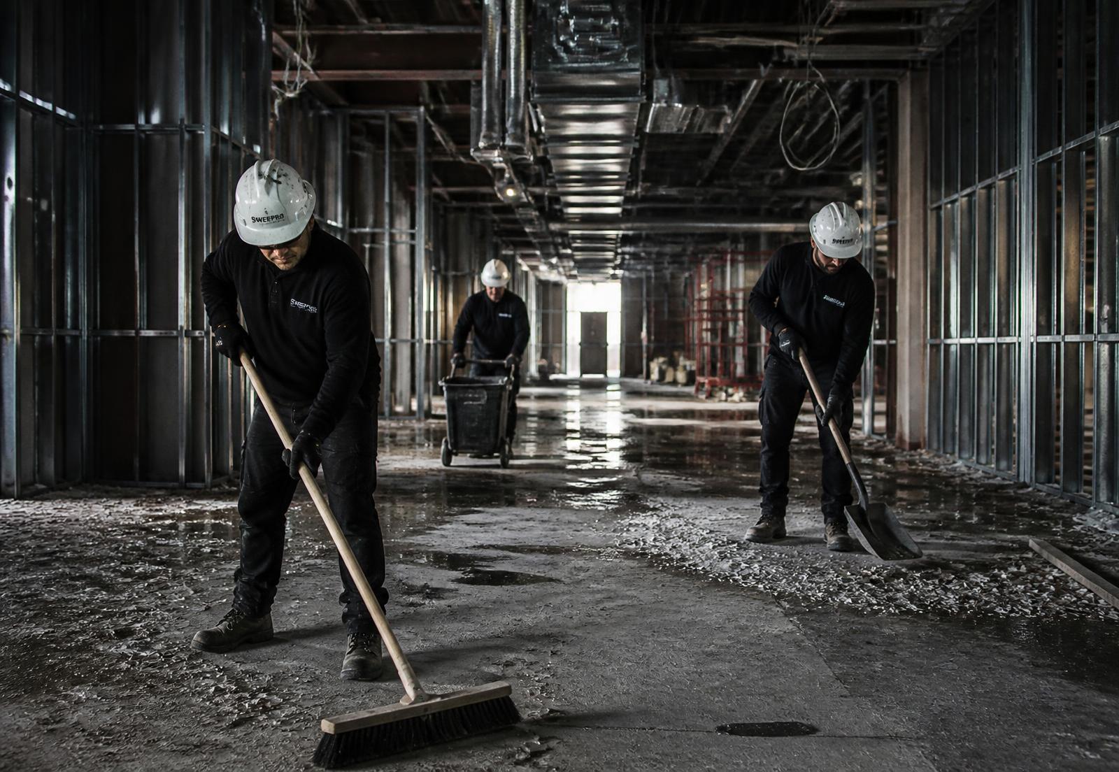 Cleanup crew working inside a commercial construction site